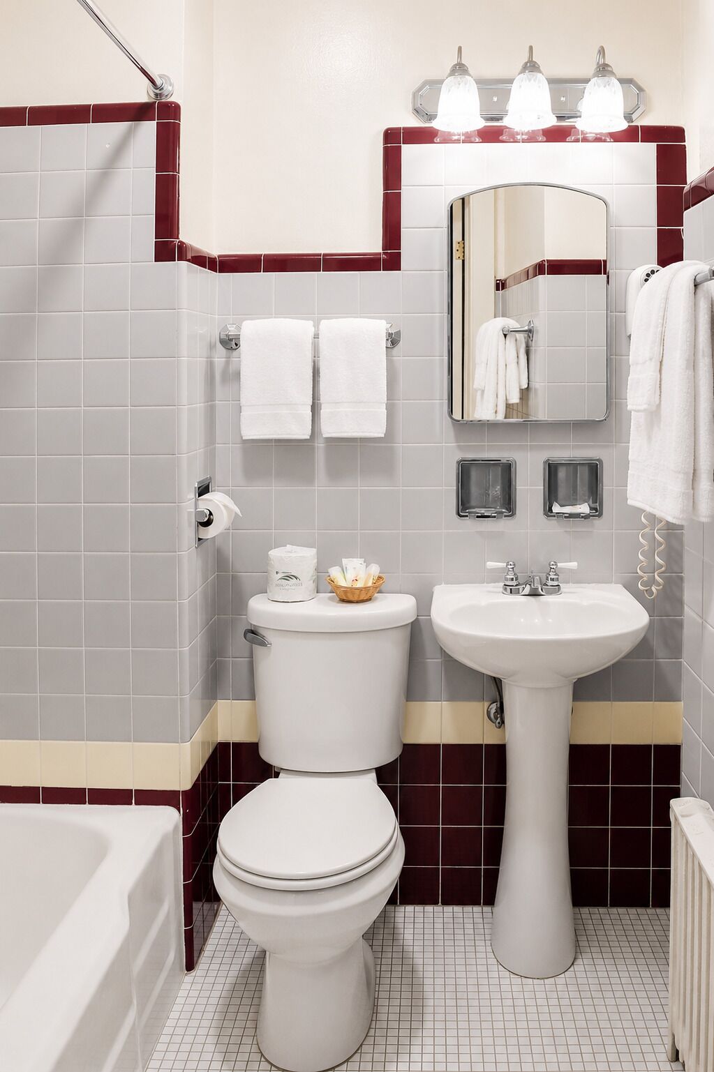 A bathroom with a toilet, sink, and bathtub.