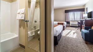 A hotel room with a shower, a bathtub, a toilet, a bed, a desk, a chair, and a television. - Comfort Inn Festus - St Louis South (Festus)