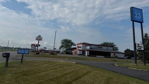 Zona comercial con un cartel de Route 23 Inn, un Tim Hortons y un edificio de techo rojo.