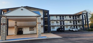 A motel with a two-story building, a covered parking area, and a visible entrance. -  Economy Suites Springfield - I-44 (Springfield)