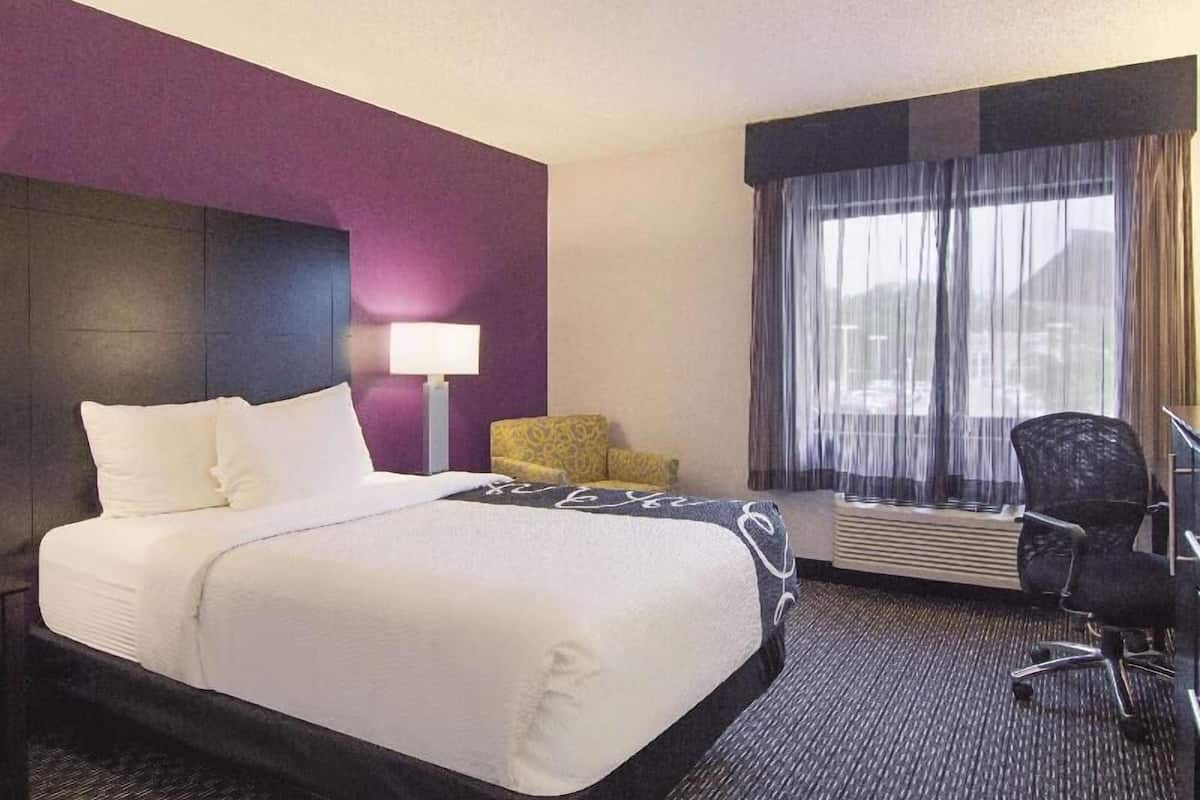 Premium bedding, desk, laptop workspace, blackout drapes