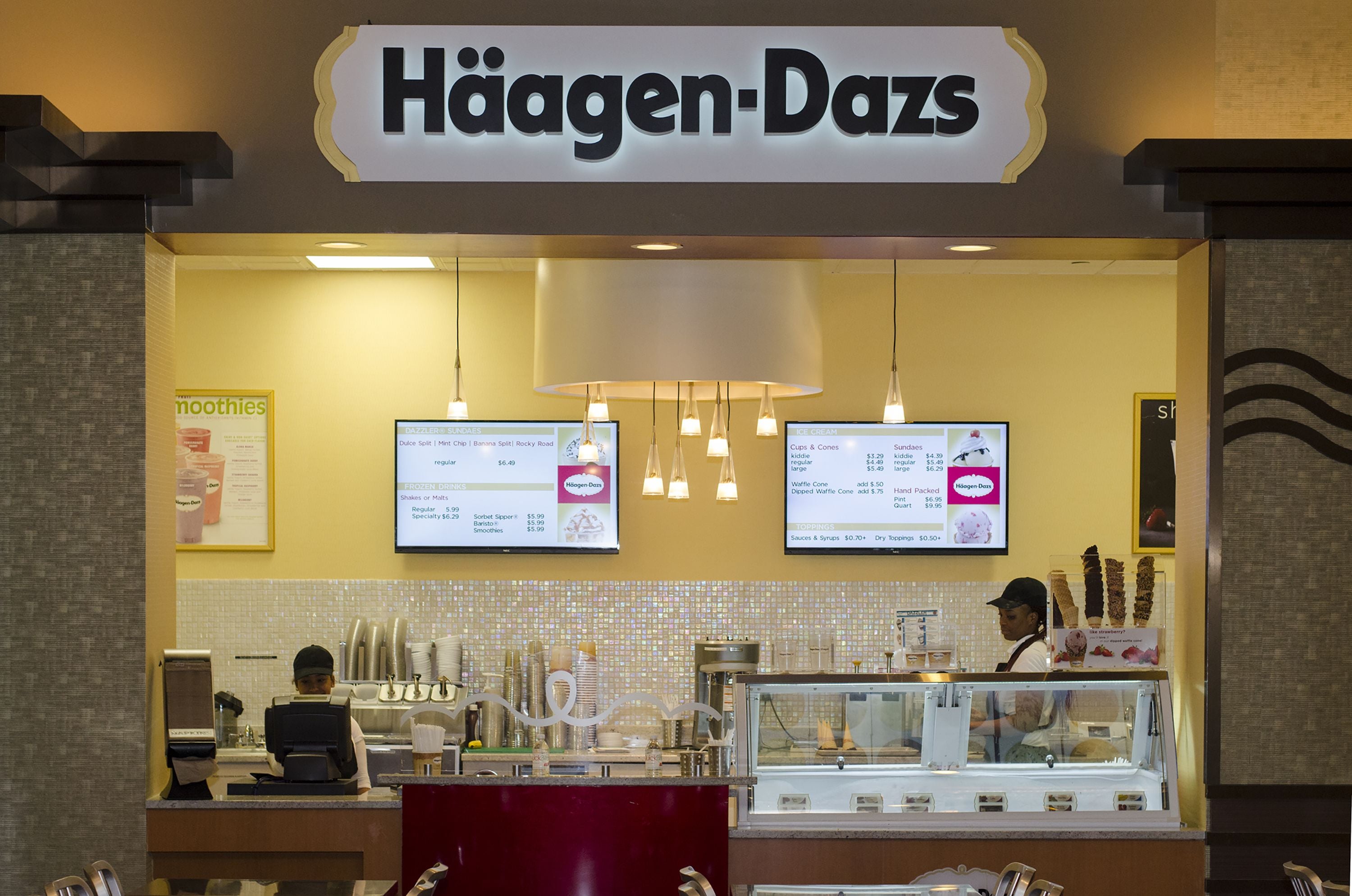 A Häagen-Dazs store with a counter, menu boards, and a display case.