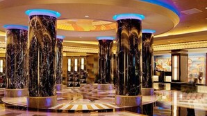A lobby with marble columns, a checkered floor, and a central light fixture. - Resorts Casino Hotel Atlantic City (Atlantic City)