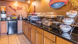 A breakfast buffet area with various food items and a coffee machine. - Baymont by Wyndham Lancaster (Lancaster)