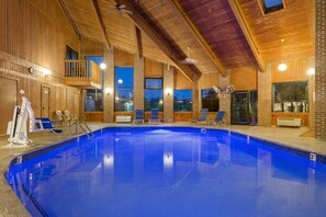 An indoor swimming pool with wooden walls and a balcony. - Baymont by Wyndham Lancaster (Lancaster)