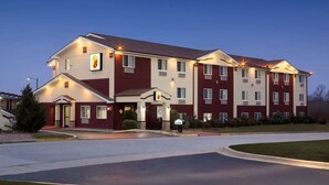A multi-story hotel with a prominent '8' sign, a central entrance, and a landscaped driveway. - Super 8 by Wyndham Joplin (Joplin)