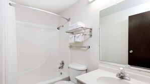 A bathroom with a bathtub, toilet, sink, and a towel rack. - Super 8 by Wyndham Norfolk (Norfolk)