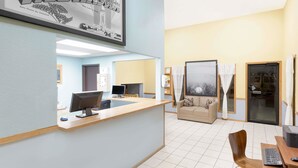 A reception area with a desk, computer, and seating area. - Super 8 by Wyndham Norfolk (Norfolk)