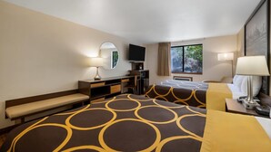 A hotel room with two beds, a desk, a chair, a television, and a window with a view of trees. - Super 8 by Wyndham Cody (Cody)