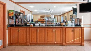 A hotel kitchen with a wooden counter, coffee machines, and a large mirror. - La Quinta Inn & Suites by Wyndham Albuquerque Journal Ctr NW (Albuquerque)