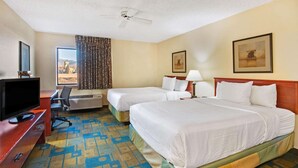 A hotel room with two beds, a desk with a TV, a ceiling fan, and a window with curtains. - La Quinta Inn & Suites by Wyndham Albuquerque Journal Ctr NW (Albuquerque)