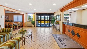 A hotel lobby with a reception desk, seating area, and a view of the outside. - La Quinta Inn & Suites by Wyndham Albuquerque Journal Ctr NW (Albuquerque)