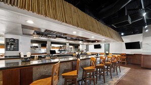 A modern bar area with wooden chairs and a counter. - Best Western Orlando Gateway Hotel (Orlando)