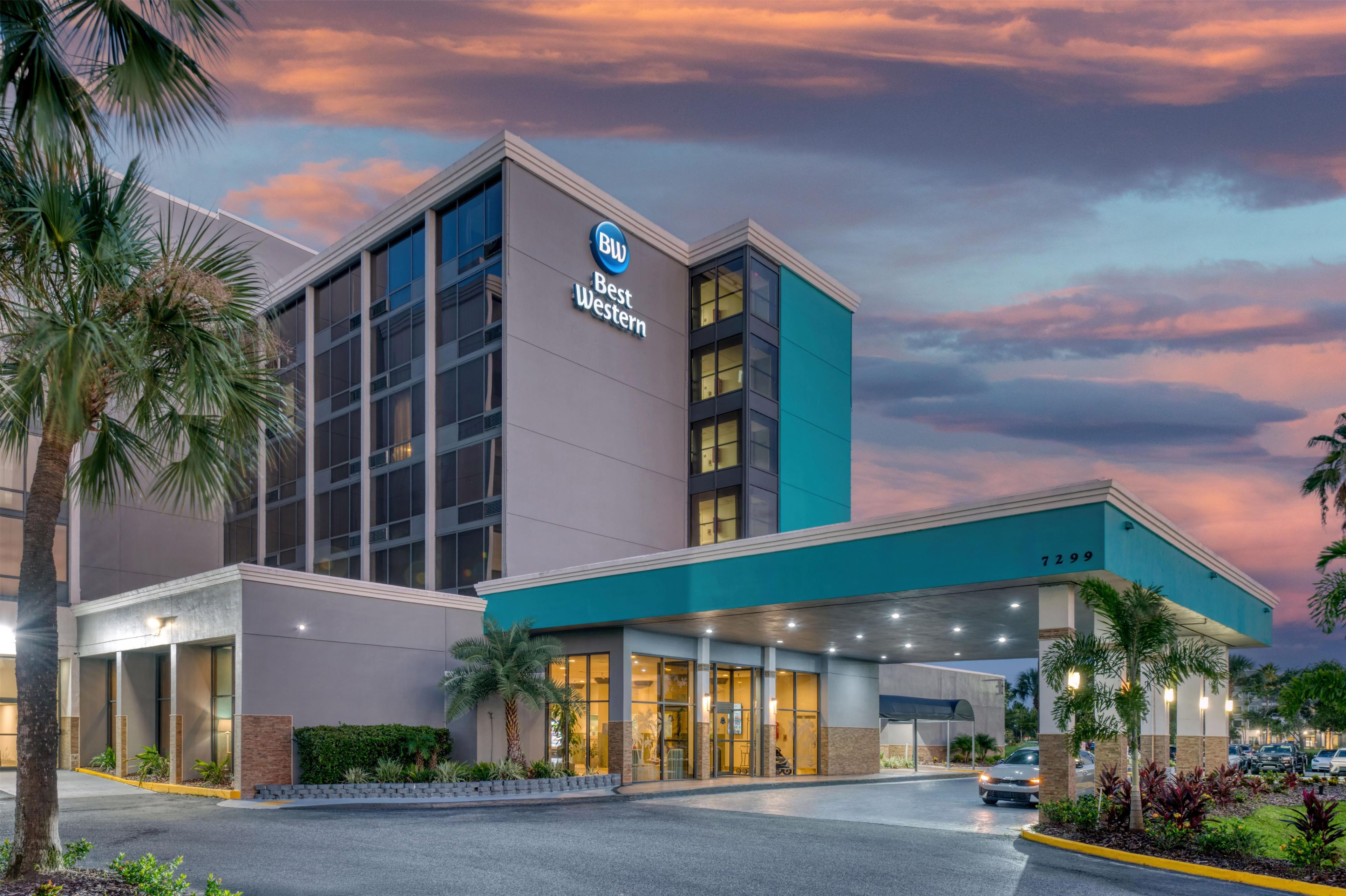A hotel with a modern facade, a prominent Best Western sign, and a covered entrance area.