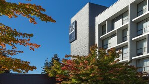 A modern building with a sign indicating room number 116, part of a hotel complex.