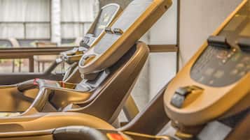 A row of seats with headrests and a control panel.