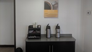 A modern kitchen with a coffee station, including a coffee maker, a thermos, and a coffee pod holder. - Motel 6 Chattanooga, TN - Airport (Chattanooga)