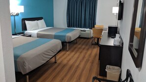 A hotel room with two beds, a desk, a chair, a TV, and a window with curtains. - Motel 6 Chattanooga, TN - Airport (Chattanooga)