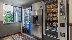A vending area with a water dispenser, a refrigerated beverage machine, and a snack vending machine. - Best Western Alderwood (Lynnwood)