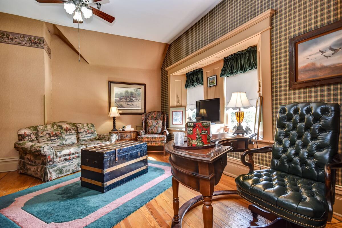 A living room with a sofa, a chair, a table, and a decorative box.