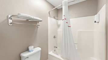 A bathroom with a toilet, a shower, and a towel rack.