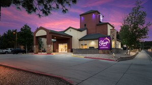 A Sleep Inn hotel with a prominent sign, a large parking lot, and a well-lit entrance.