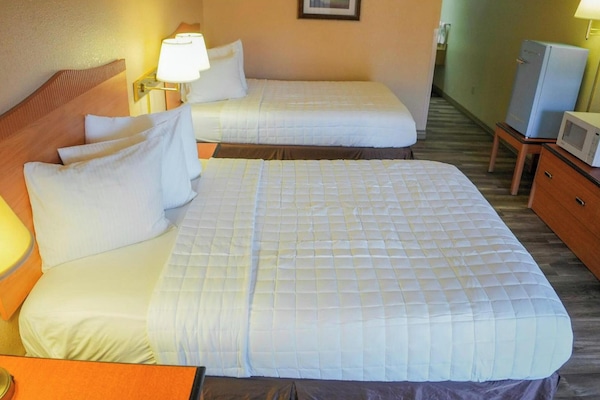 Desk, bed sheets, alarm clocks