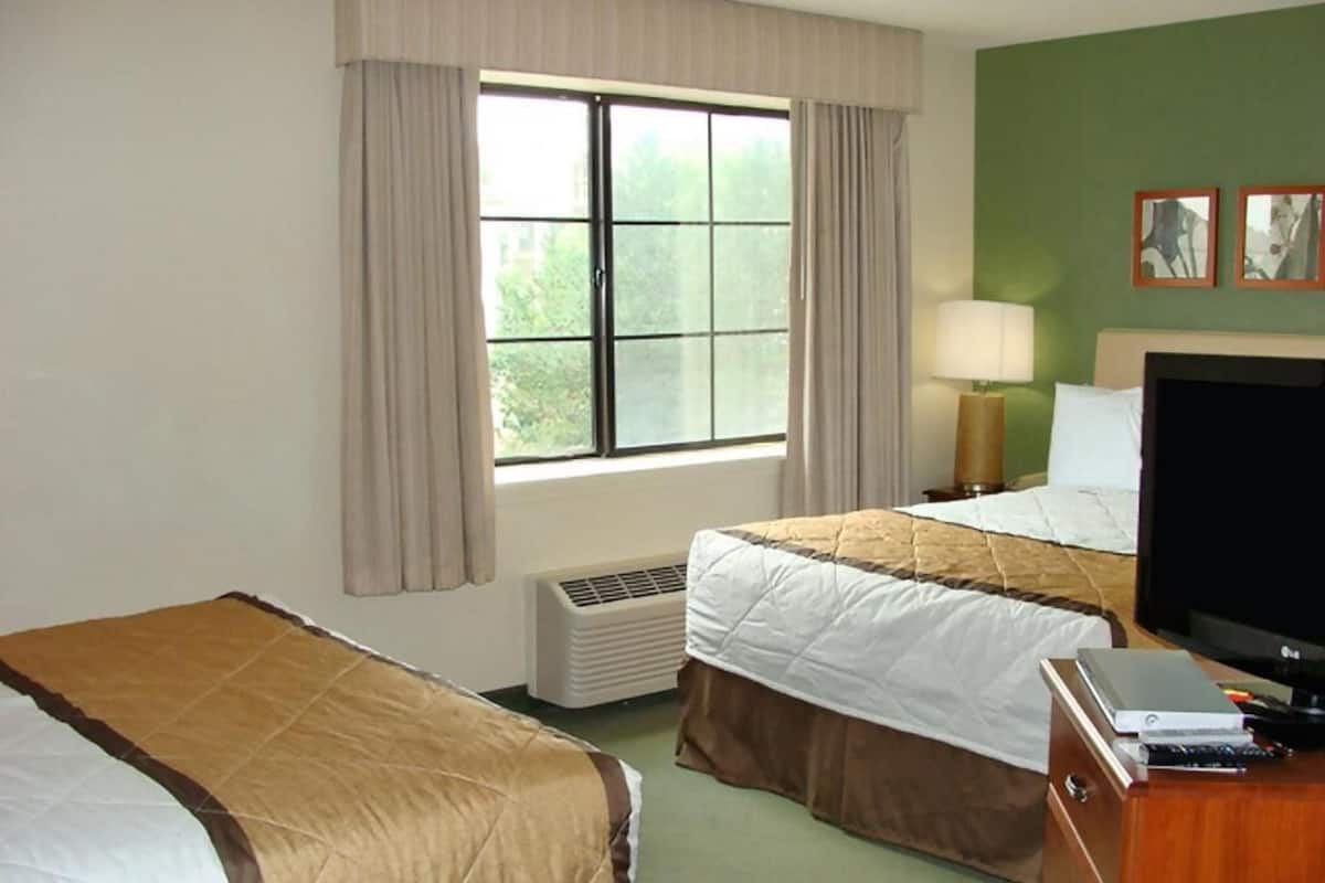 Premium bedding, desk, laptop workspace, iron/ironing board