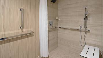 A modern shower area with a wooden wall, a white shower curtain, and a handheld showerhead.