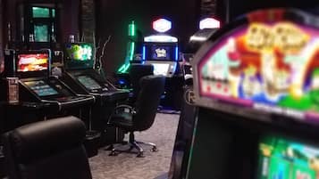 Experience the ultimate gaming destination with a range of arcade machines and a comfortable seating area.