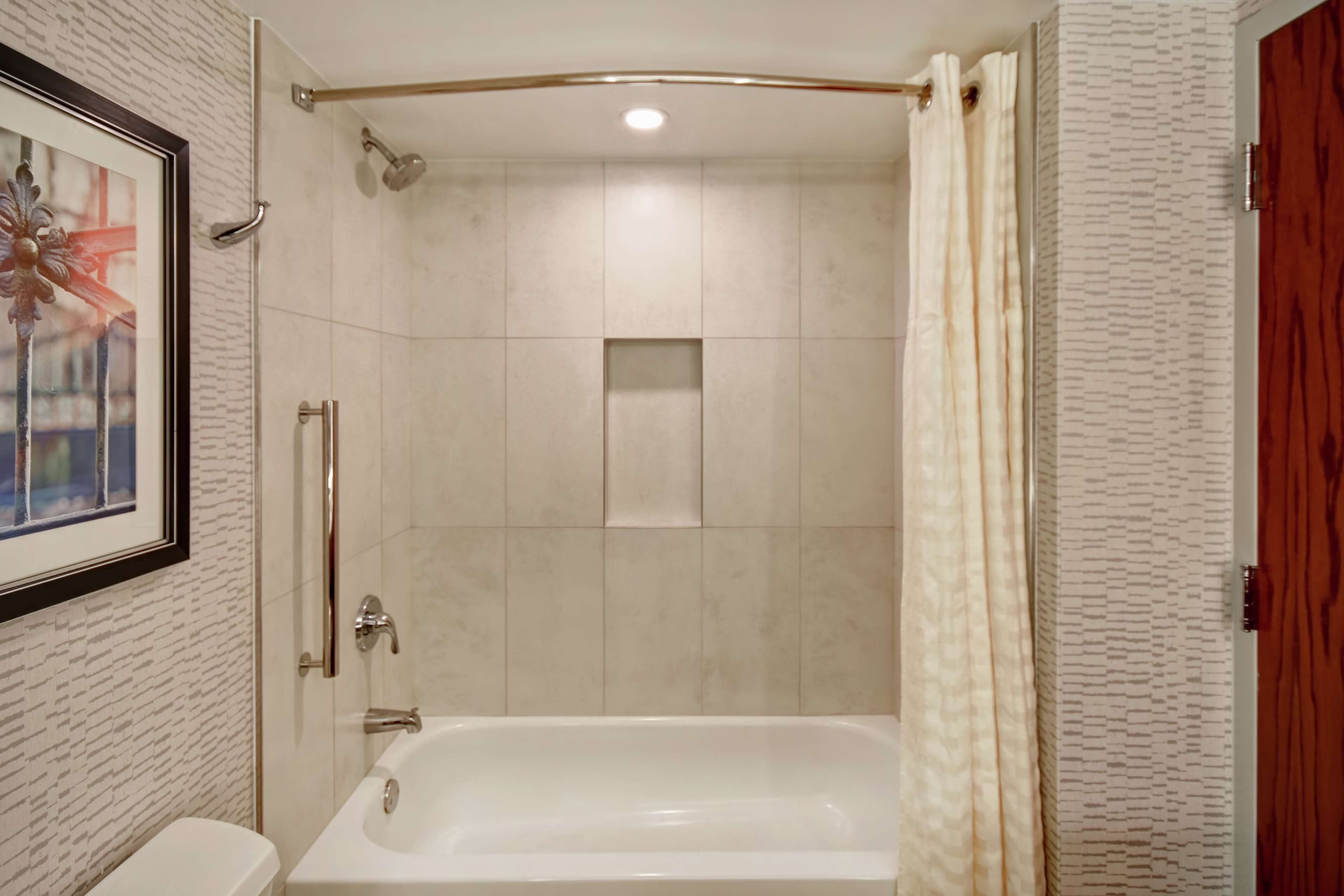 A bathroom with a bathtub, a shower, and a toilet.