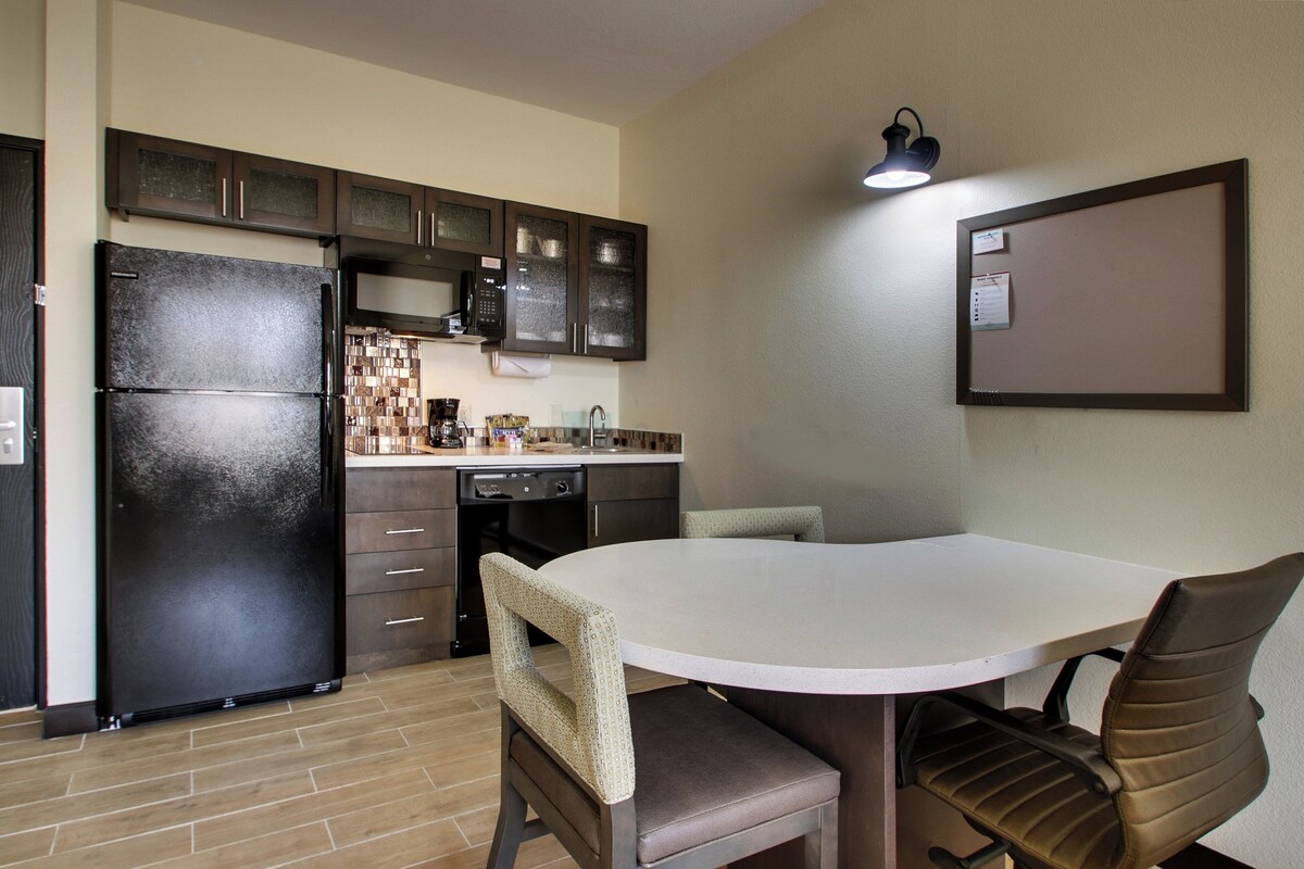 Premium bedding, desk, laptop workspace, blackout drapes