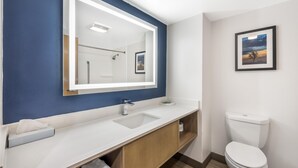 A modern bathroom with a white sink, a mirror, and a toilet. - Best Western Inn Florence (Florence)