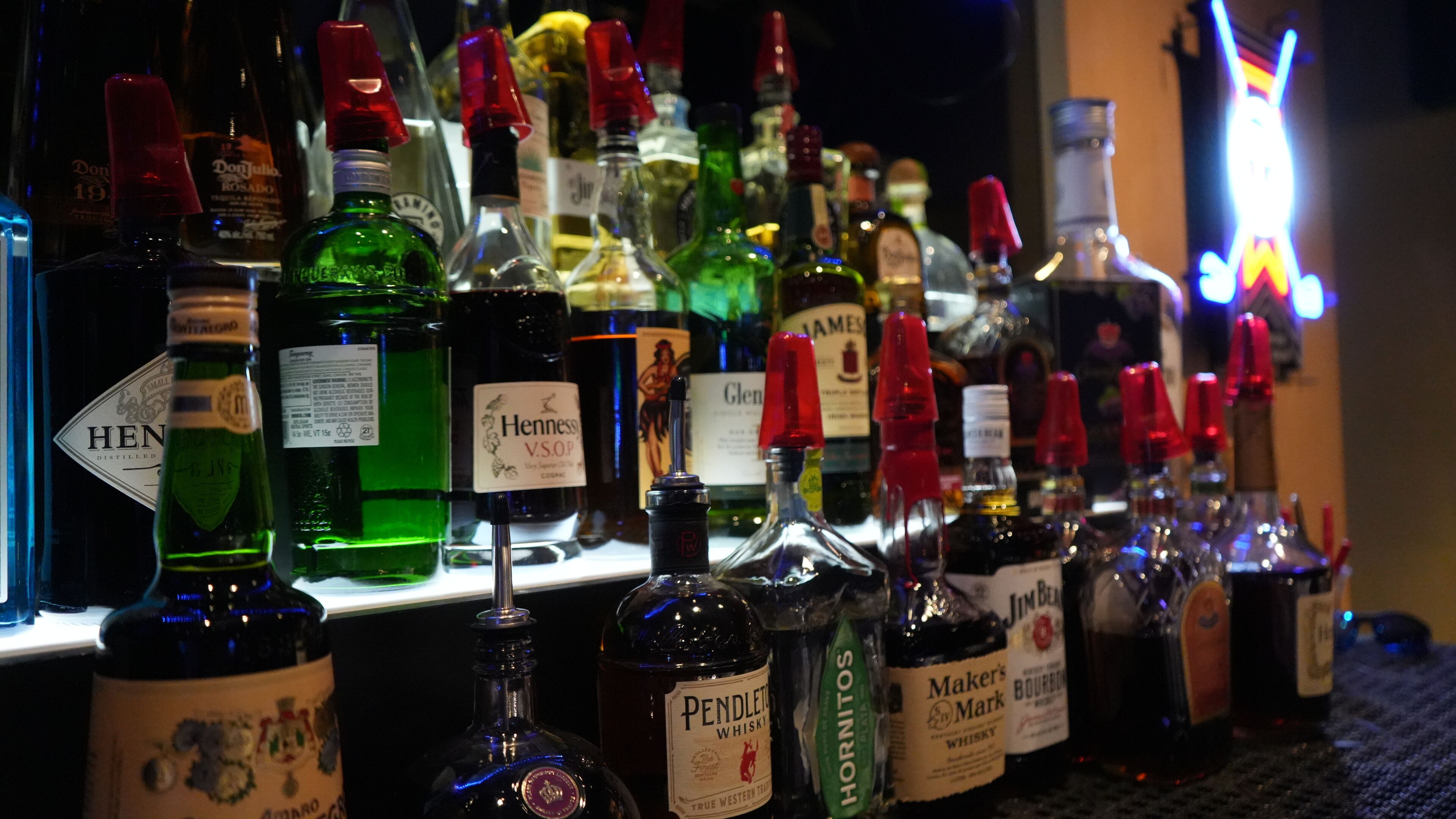 A bar with various bottles of alcohol, including whiskey and other spirits.