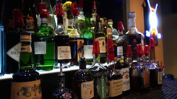 A bar with various bottles of alcohol, including whiskey and other spirits.