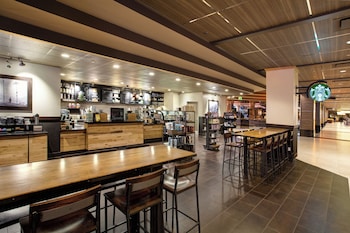 A hotel lobby with multiple seating areas, a reception desk, and a large chandelier. at Nugget Casino Resort