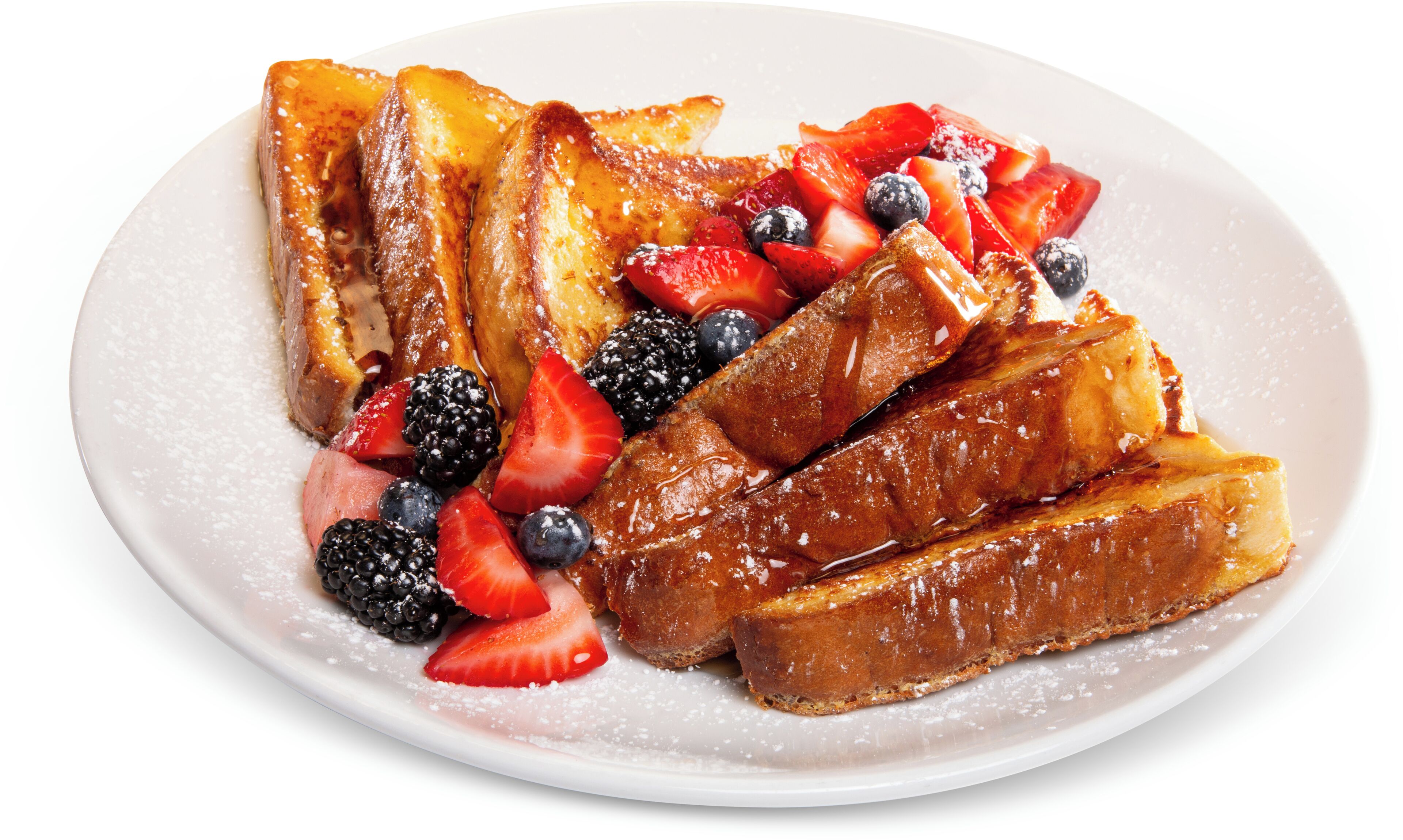 A plate of French toast with strawberries, blueberries, and blackberries.