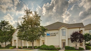 A hotel with a 'Hyatt House' sign, surrounded by well-maintained landscaping and trees. - HYATT house Mt. Laurel (Mount Laurel)