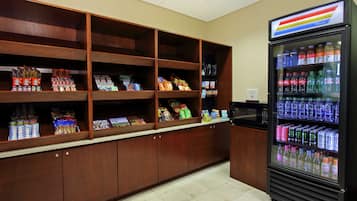 A vending area with snack and drink options, including a refrigerated drink cooler.