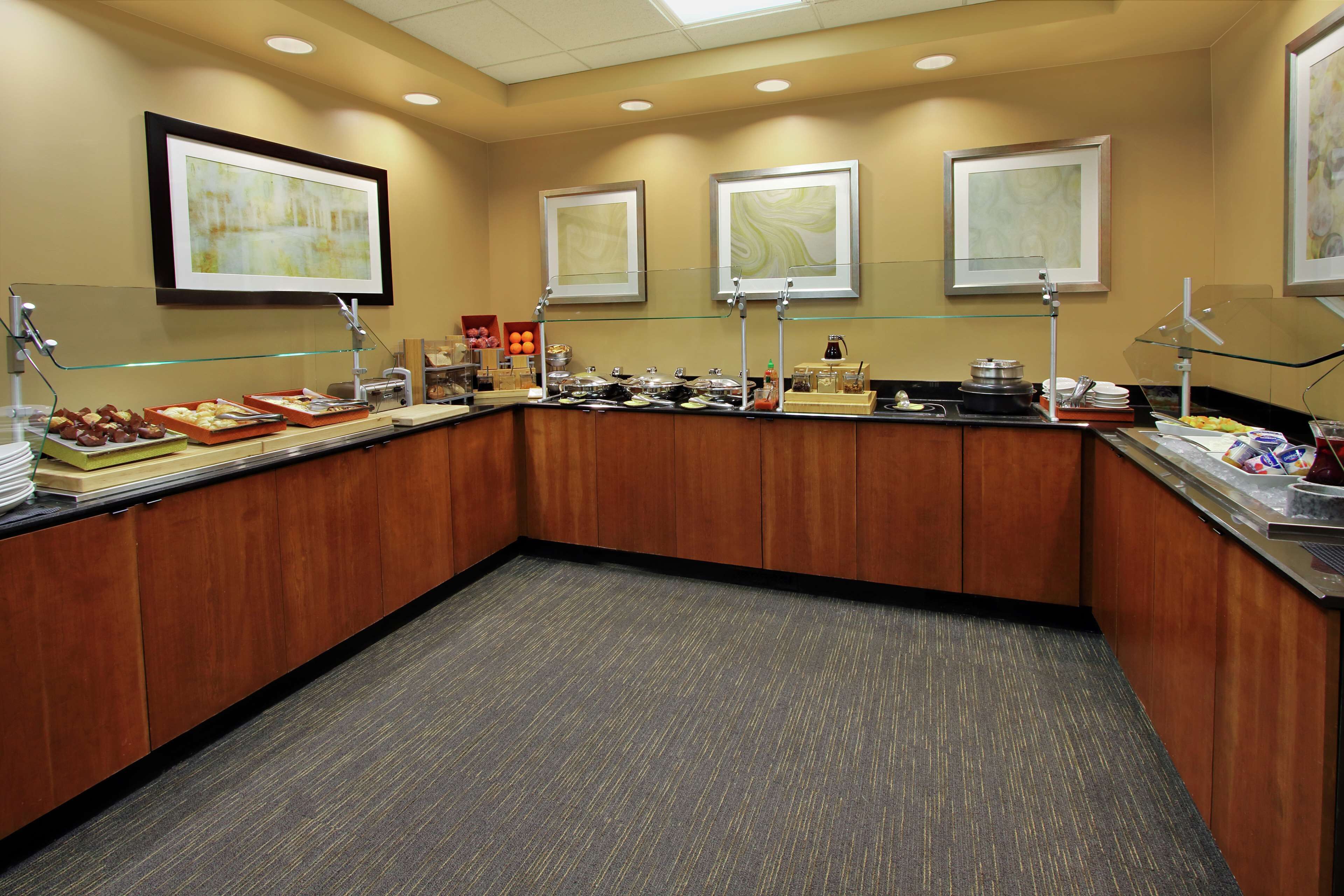 A buffet area with various food items and a coffee station.
