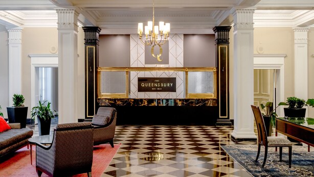 A lobby with a checkered floor, a chandelier, and a sign reading "The Queensbury." - The Queensbury Hotel (Glens Falls)