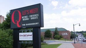 A sign for 'The Queensbury' with a large 'Q' logo, indicating a venue for meetings, conferences, weddings, and banquets. - The Queensbury Hotel (Glens Falls)