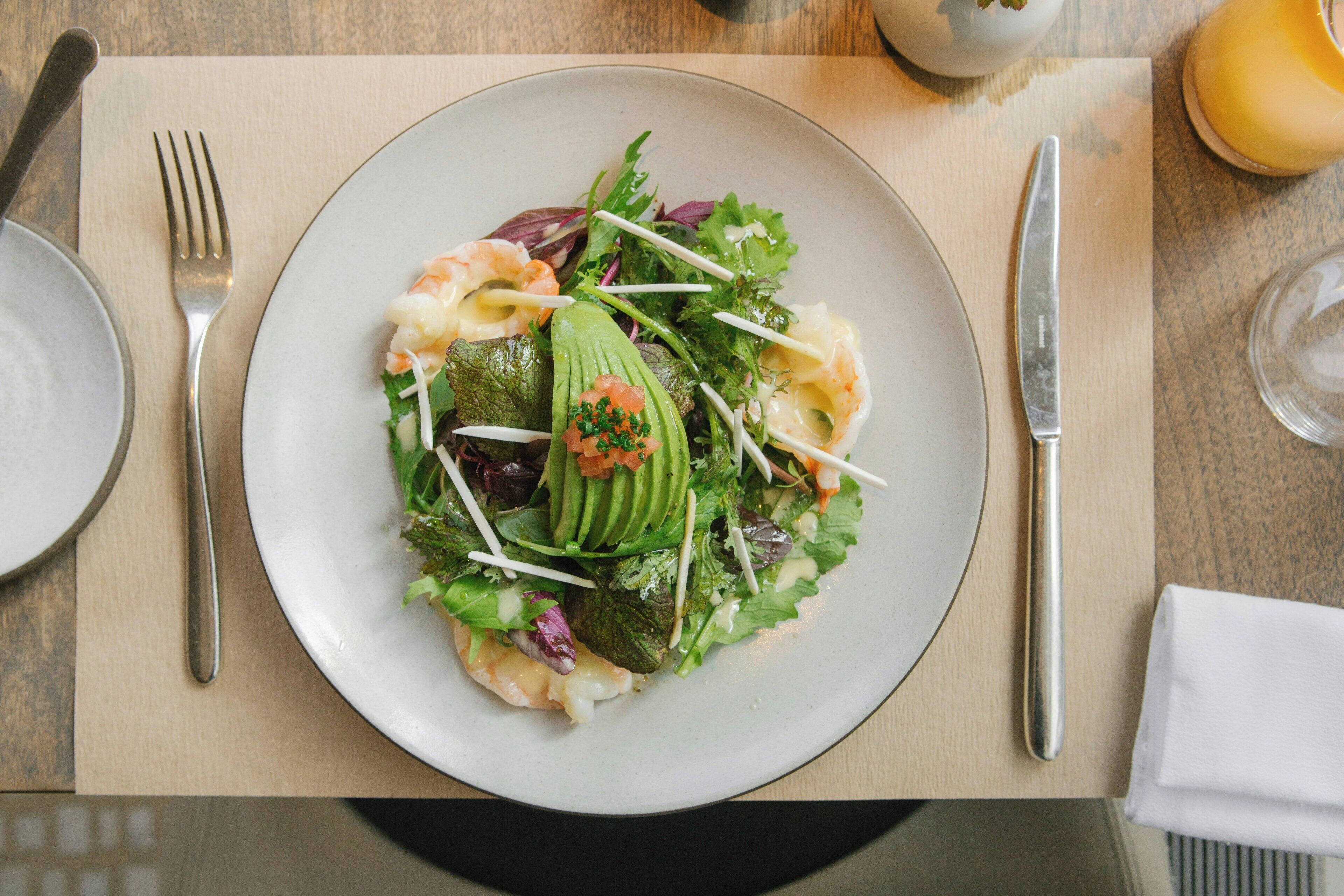 A plate of food with various ingredients on a table.