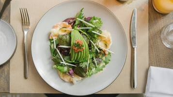 A plate of food with various ingredients on a table.