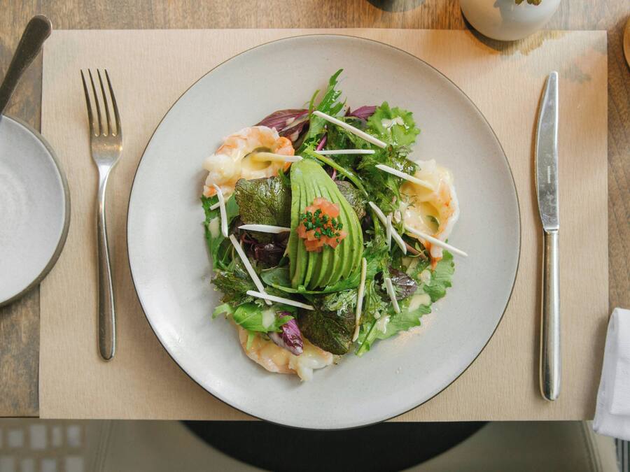 A plate of food with various ingredients on a table.