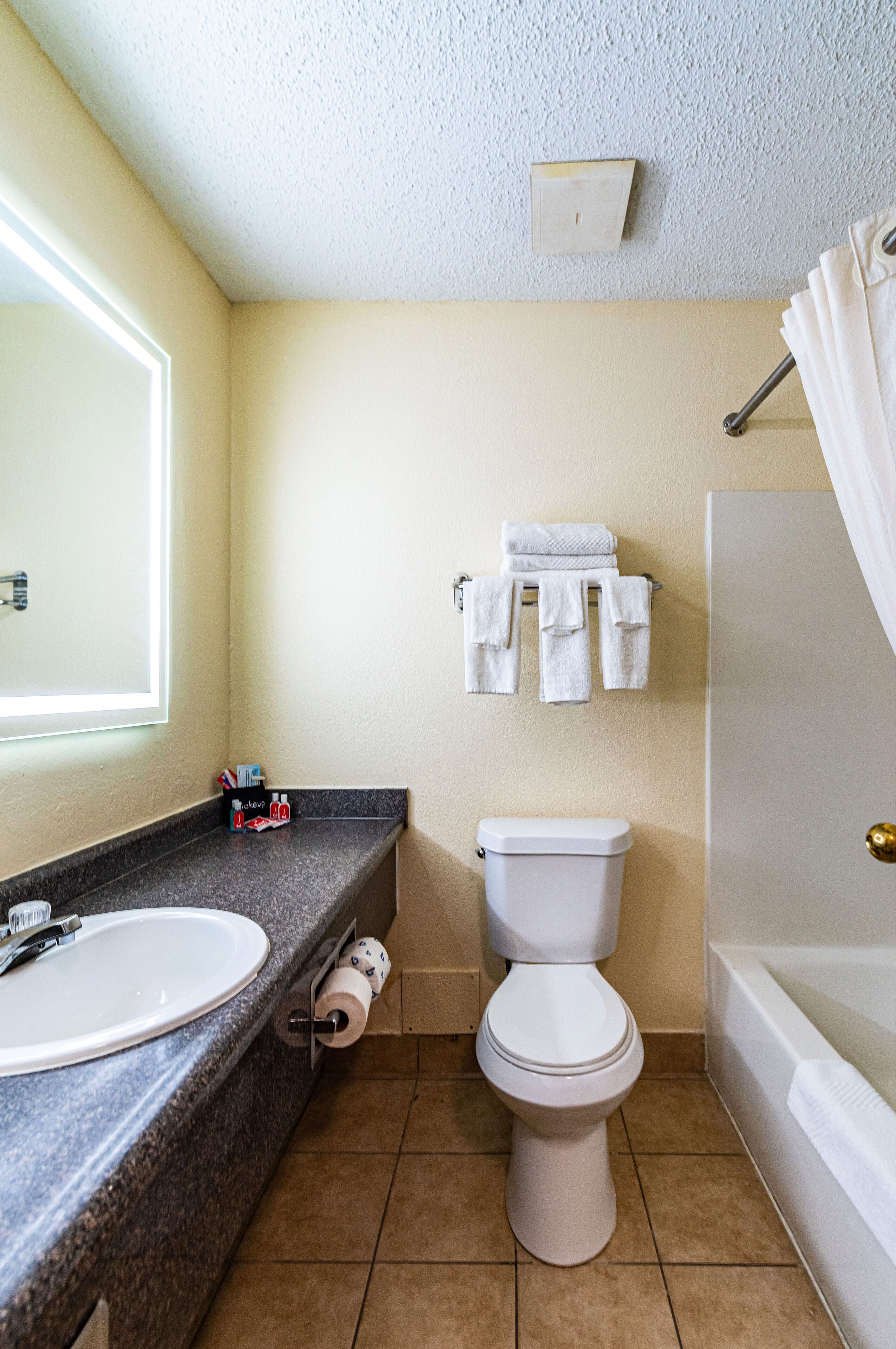 A bathroom with a sink, toilet, and bathtub.