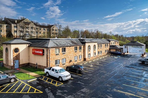 A parking lot with several cars, a building labeled "EconoLodge," and a large multi-story structure in the background.