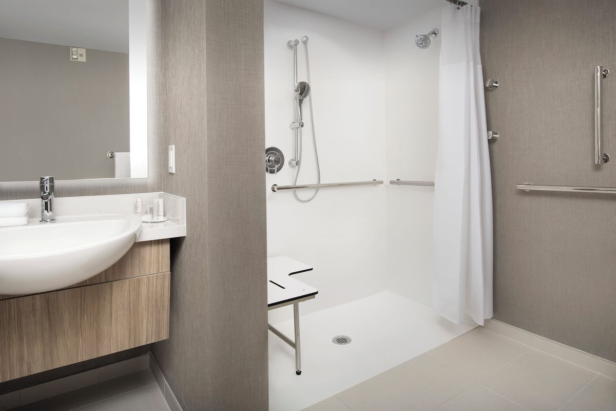 designer toiletries, hair dryer, towels