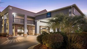 A modern hotel with a stone facade, multiple balconies, and a sign indicating it is Clarion Pointe. - Clarion pointe near I-75 (Forsyth)