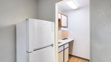 Full-size fridge, microwave, stovetop, dining tables